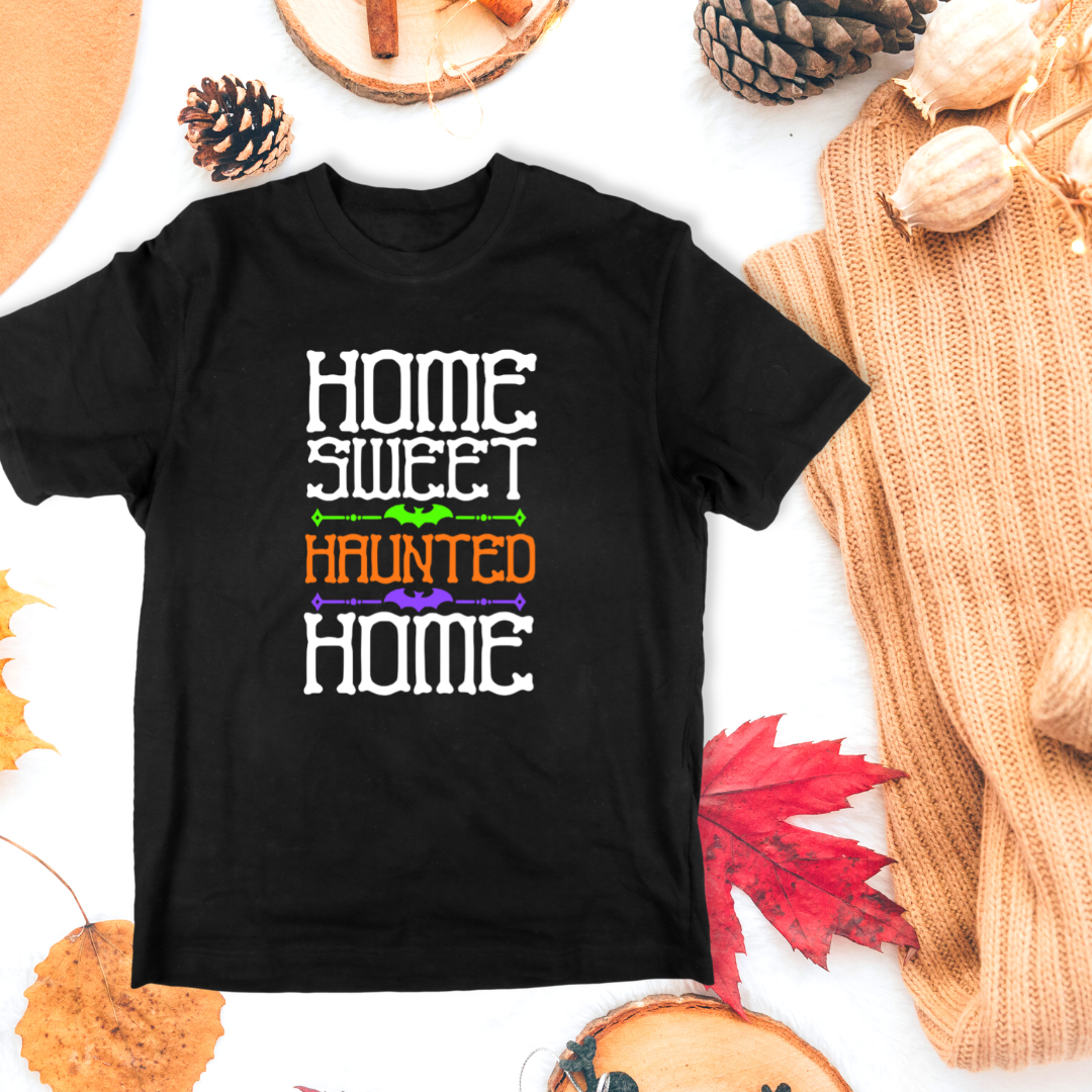 Black t-shirt with 'Home Sweet Haunted Home' text on a white background with autumn decorations.