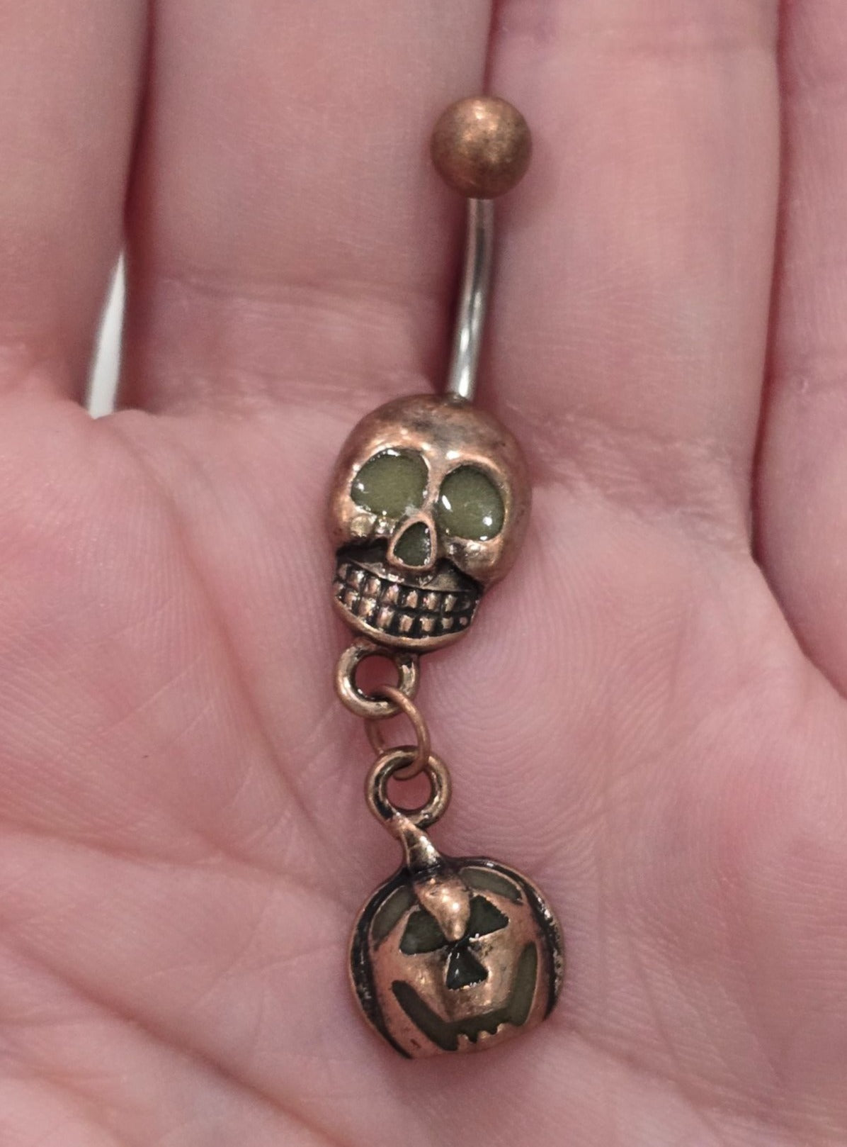 Painful Pleasures Skull & Pumpkin Glow Navel Ring in 14G Surgical Steel